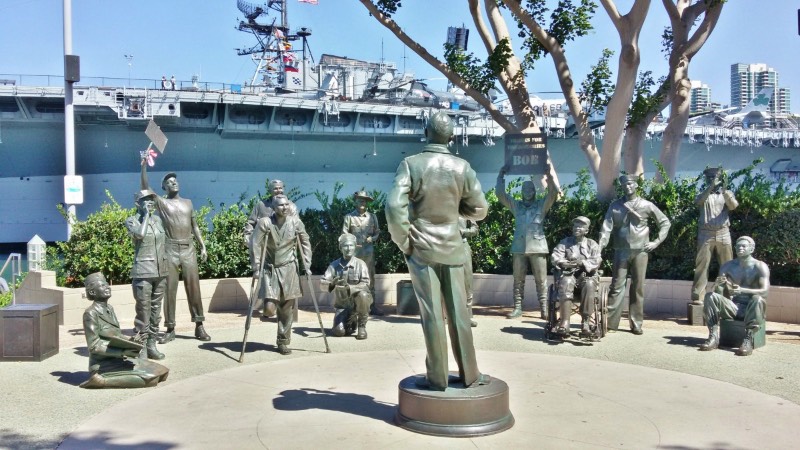 San Diego's Downtown Harbor and Bob Hope Tribute Another San Diego must-see is the downtown harbor. As you stroll along the waterfront, you will see cruise ships preparing to embark, historic merchant vessels, the USS Midway museum, and the quaint Seaport Village where you can ride an antique carousel or eat in a harborside restaurant. My personal favorite is Tuna Harbor Park, right next to the USS Midway. There's a Bob Hope tribute there and a huge replica of the 'Kissing Sailor' statue. You can bring a picnic here or meander down to the 'G' Street pier and watch the fishermen get their nets and traps ready.
