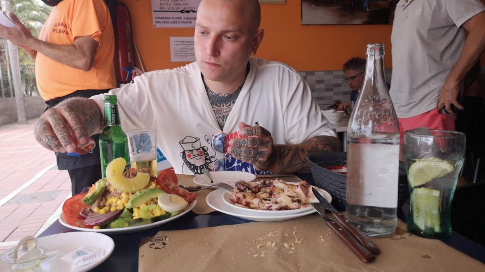 tattoos by mariano eating calamaris at restaurant nuevo gran playa