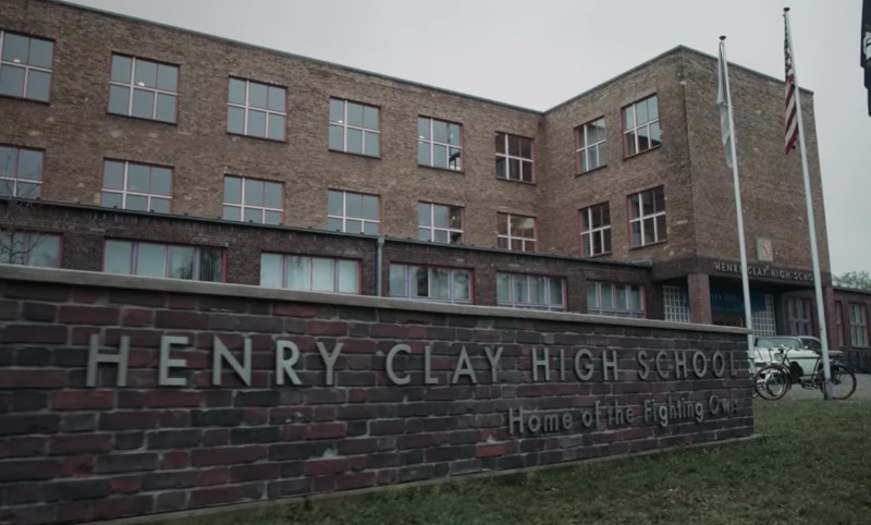 When Beth Harmon plays in her first chess competition, she heads to the Henry Clay High School in Lexington. We can see some shots from the outside area in the series, with a building made of bricks. Most of the scenes are inside a building, in what seems to be a gymnasium. 