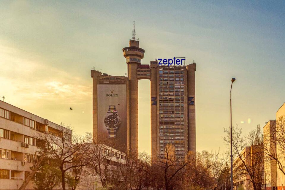 The Western City Gate, also known as Genex Tower or Kula Geneks in Serbian, is a massive skyscraper in Belgrade and can be seen from all around town. The 35 storeys tall building is an icon of architectural brutalism with its two connected towers and even a revolving restaurant that feels like a crown over everything.