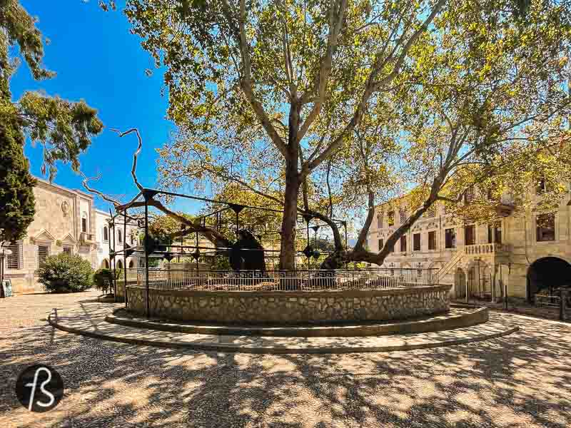 The tree can be found in the middle of a square called Platía Platanoú, surrounded by a short wall. On the north side of this wall, you can see an ancient sarcophagus converted into a fountain during the Ottoman Empire control of the island. An Arab inscription on the casket calls this water the Water of Hippocrates, and you can still drink it today as we did on the hot day we were in Kos.