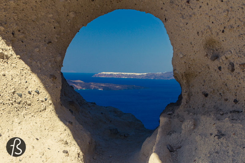 This downhill path led to a cobblestone stair that was made of broad steps. On the right side, there was a hole in the white volcanic ash of the cliff, and, we believe, this is the heart of Santorini. A small cave-like hole that must be an Instagram hotspot for those who decide to wander around and see more than just the towns of Fira and Oia. 