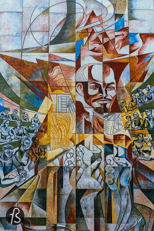This Lenin mural in Halle Neustadt was unveiled in 1971 by Erich Enge, a bricklayer by training who found himself in large format paintings. His mural is named "He stirred the sleep of the world" and visually presents the three essential reforms that Lenin initiated in the Soviet Union. First, with the elimination of illiteracy, followed by a country comprehensive land reform and the country's electrification in the 1920s. All these elements are presented around Lenin's face in the mural, surrounded by young people reading and learning.