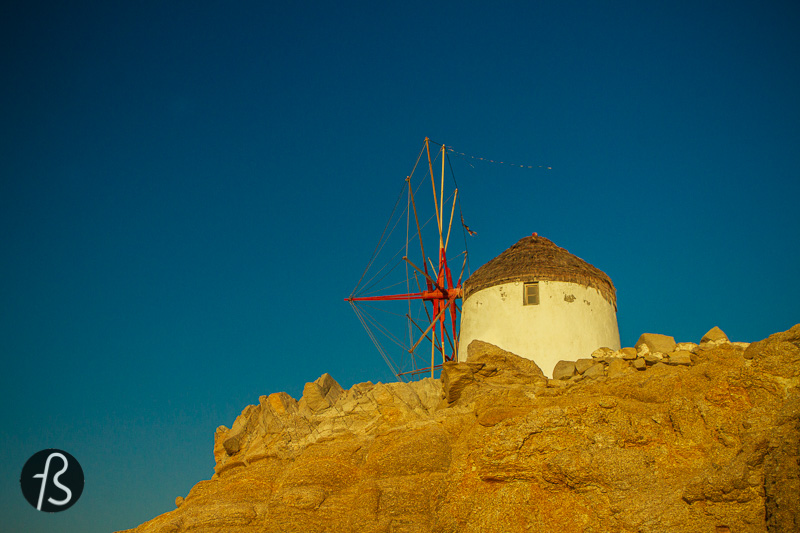 The traditional way of building the windmills of Mykonos is simple. They were all spherical shaped, made of stones sourced locally and a pointed roof at the top made of wood. Today, they are all painted white which blends quite well with the other buildings spread around the island and looks gorgeous in contrast to the blue from the Aegean sea.