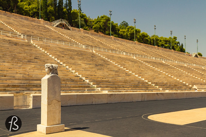 Outside Athens, the Panathenaic Stadium started as a racecourse between two hills and Agra and Ardettos. Next to it, the Ilissos river used to flow, and we can only imagine how idyllic this place used to be in ancient times. Nowadays, the river flows under the Vasileos Konstantinou Avenue, and the atmosphere around the stadium feels quite busy. But, it's still a fantastic place to visit in Athens!